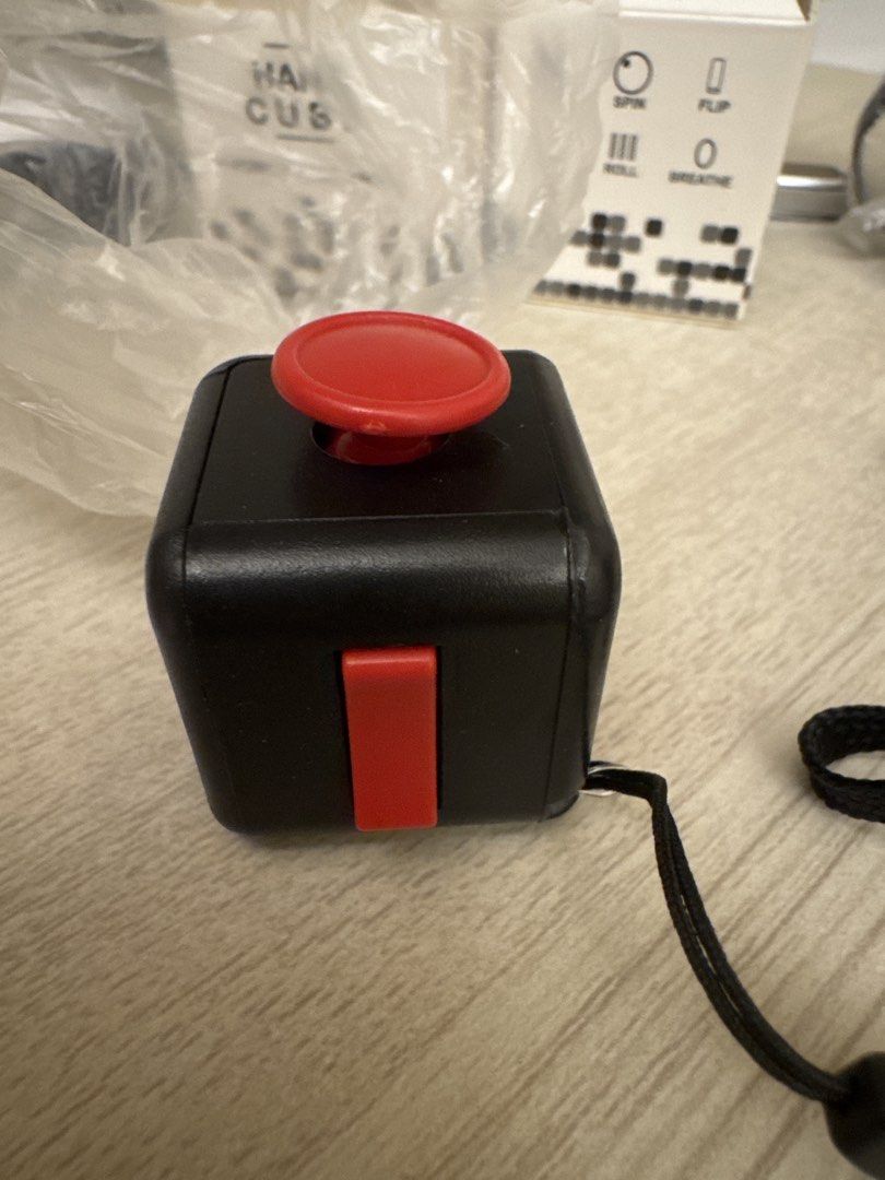 Fidget Cube (Category: Interactive Toys) located in Singapore. Submitted by activesell (Listing ID 1441334872, Image 3). Description: Brand new have 2 in stock. One with red buttons and one with black buttons. $2 each.
