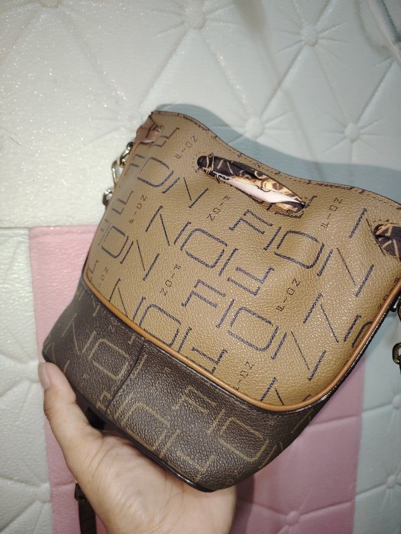Fion mini bucket bag (Category: Luxury Bags & Wallets) located in Bulacan. Submitted by jhefkheelo02163 (Listing ID 1441159743, Image 3). Description: Fion mini bucket bag Kasya cp and med size wallet Likenew Super nice in actual .