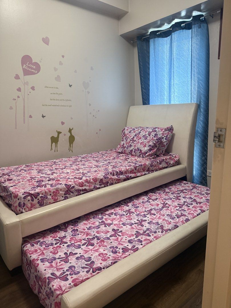 Single Bed with Pull-Out Bed and Mattresses (Category: Bed Frames & Mattresses) located in Mandaluyong City. Submitted by prelovedbyn_ph (Listing ID 1441183629, Image 3). Description: Features: - Space-saving pull-out trundle design - White faux leather upholstery - Includes 2 mattresses - Sturdy and comfortable Measurements: Bed Frame - Length: 85 in - Width: 44 in - Height from Floor to Top of Bed Frame: 45.5 in - Height from Floor to Mattress: