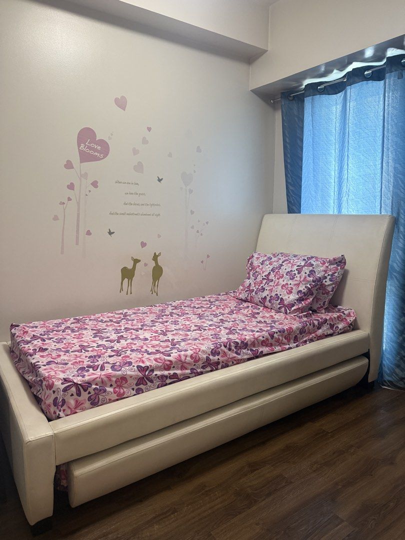 Single Bed with Pull-Out Bed and Mattresses (Category: Bed Frames & Mattresses) located in Mandaluyong City. Submitted by prelovedbyn_ph (Listing ID 1441183629, Image 1). Description: Features: - Space-saving pull-out trundle design - White faux leather upholstery - Includes 2 mattresses - Sturdy and comfortable Measurements: Bed Frame - Length: 85 in - Width: 44 in - Height from Floor to Top of Bed Frame: 45.5 in - Height from Floor to Mattress: