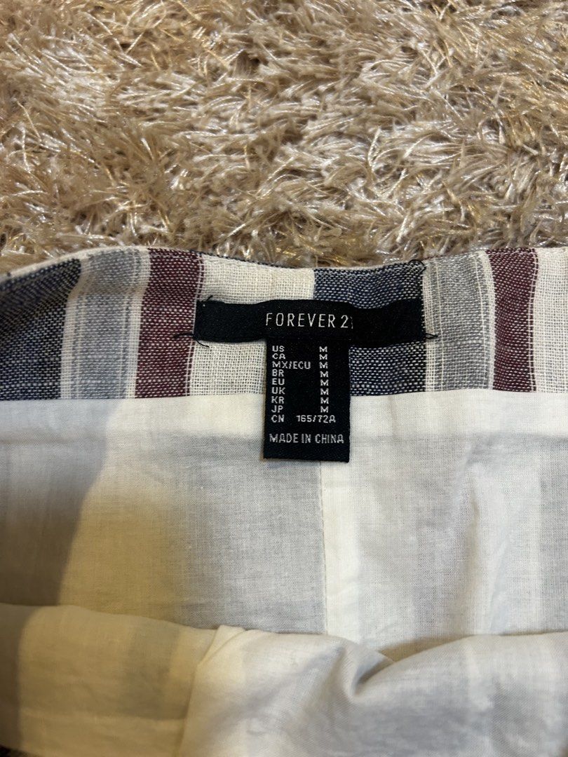Forever 21 Striped Mini Skirt Size M (Category: Skirts) located in Muntinlupa City. Submitted by vans_19 (Listing ID 1441226341, Image 2). Description: - Cute mini skirt from Forever 21 - Features vertical stripes in navy, burgundy, and cream - Ideal for casual wear - Easy to style with a simple top.