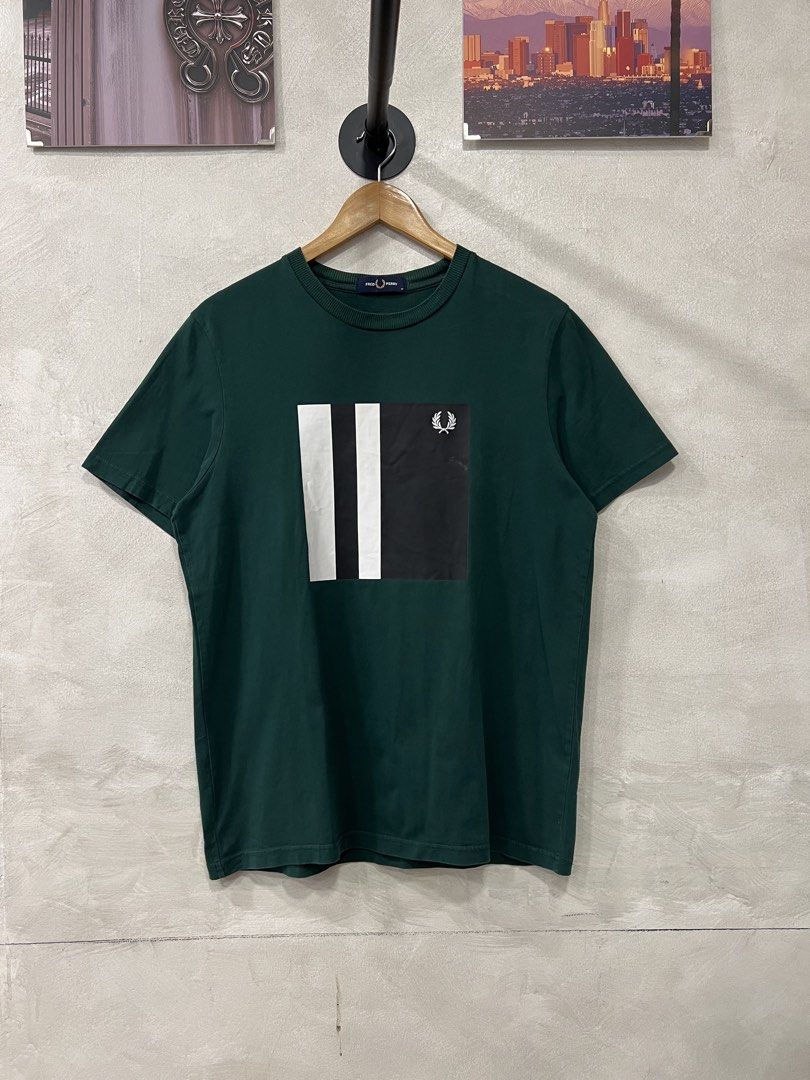 Fred Perry Men's printed T-Shirt (Category: Tshirts & Polo Shirts ) located in Manila. Submitted by -handpick- (Listing ID 1441278365, Image 2). Description: - Green Fred Perry T-shirt - Size: Medium (M) - Chest graphic block with stripe detail - Embroidered Fred Perry laurel wreath logo on graphic - Classic crew neck and short sleeves - Plain green back Dimensions : Length : 27 Width : 20.5 Issue : None .