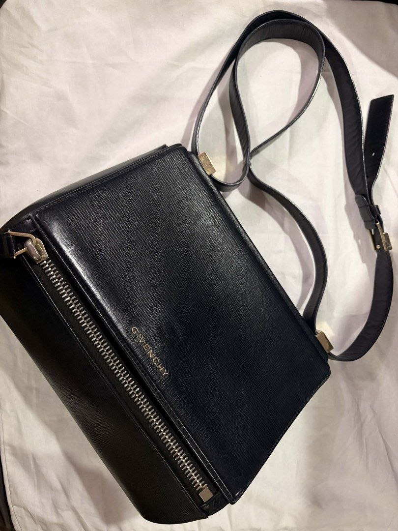 Givenchy Pandora Medium Shoulder Bag (Category: Luxury Bags & Wallets) located in Mandaluyong City. Submitted by seanytest (Listing ID 1441365129, Image 2). Description: - Authentic Givenchy black leather shoulder bag - Textured leather finish for a sophisticated look - Secure front zipper closure - Adjustable strap for comfortable wear - Elegant gold hardware details - Classic and versatile design, suitable for everyday or evening use Givenchy P