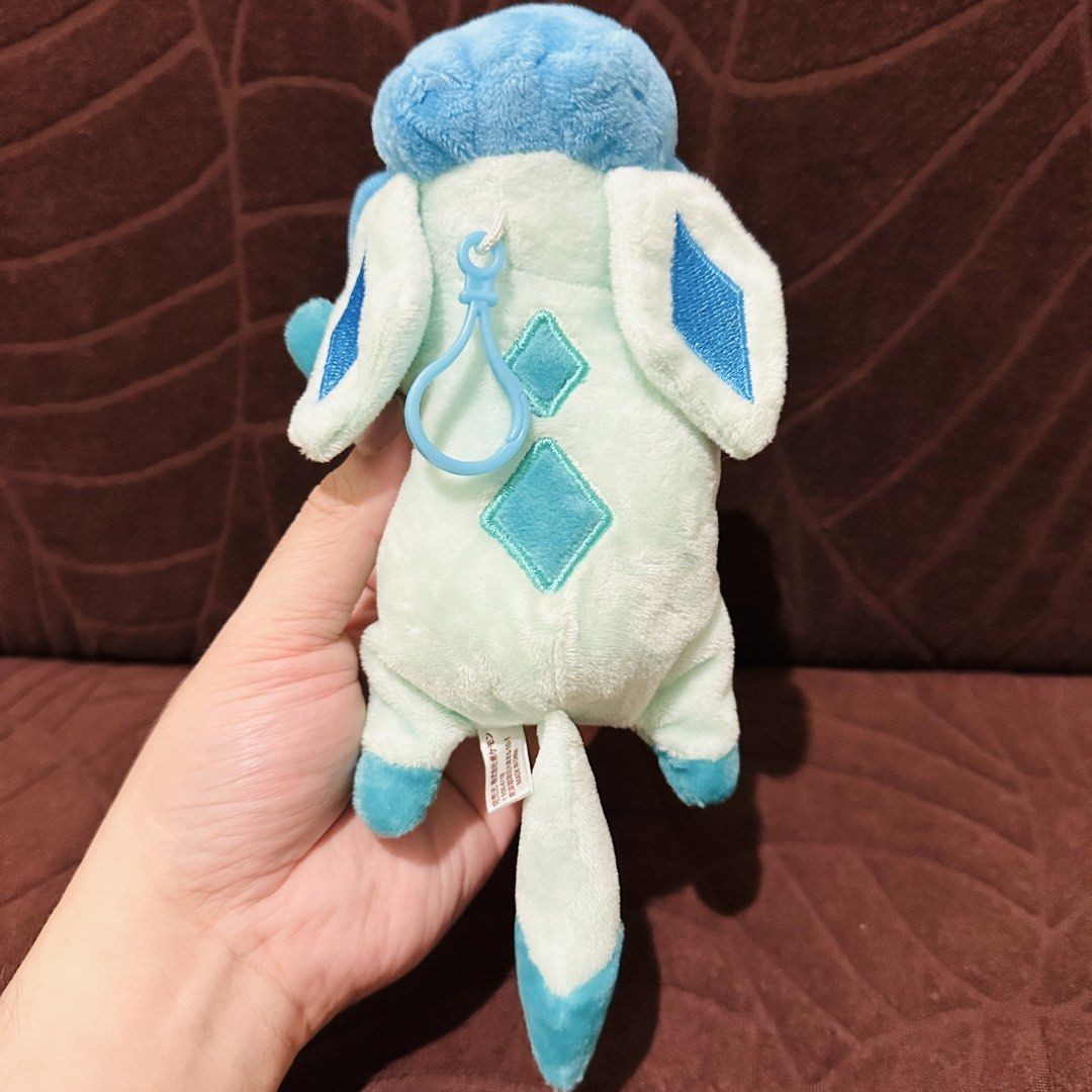 Glaceon Pokemo Plush charm (Category: Toys & Games) located in Mandaluyong City. Submitted by johnmichaelb.reyes (Listing ID 1441373418, Image 2). Description: - Adorable Glaceon plush toy from the official Pokemon Center. - Approximately 6 inches tall, perfect for display or play. - Features a convenient keychain clip, ideal for attaching to bags, backpacks, or keys. - A must-have for any Pokemon enthusiast or collector. - Released in 2017..