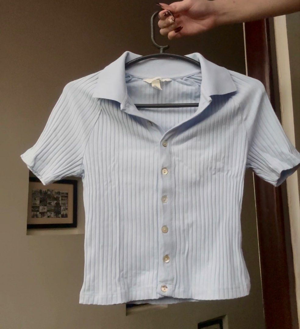 H&M Baby Blue Ribbed Button-Up Collared Top (Category: Blouses) located in Santa Rosa. Submitted by prelovedby.her_ (Listing ID 1441341711, Image 1). Description: Color: Baby Blue Size: XS Condition: No visible flaws; in great condition RFS: Decluttering 🧹 📍 Shipping from: Fairview, QC 🚚 Mode of Delivery: Lalamove | J&T 💵 Payment: GCash | Bank Transfer Feel free to message for any questions! 🤍.