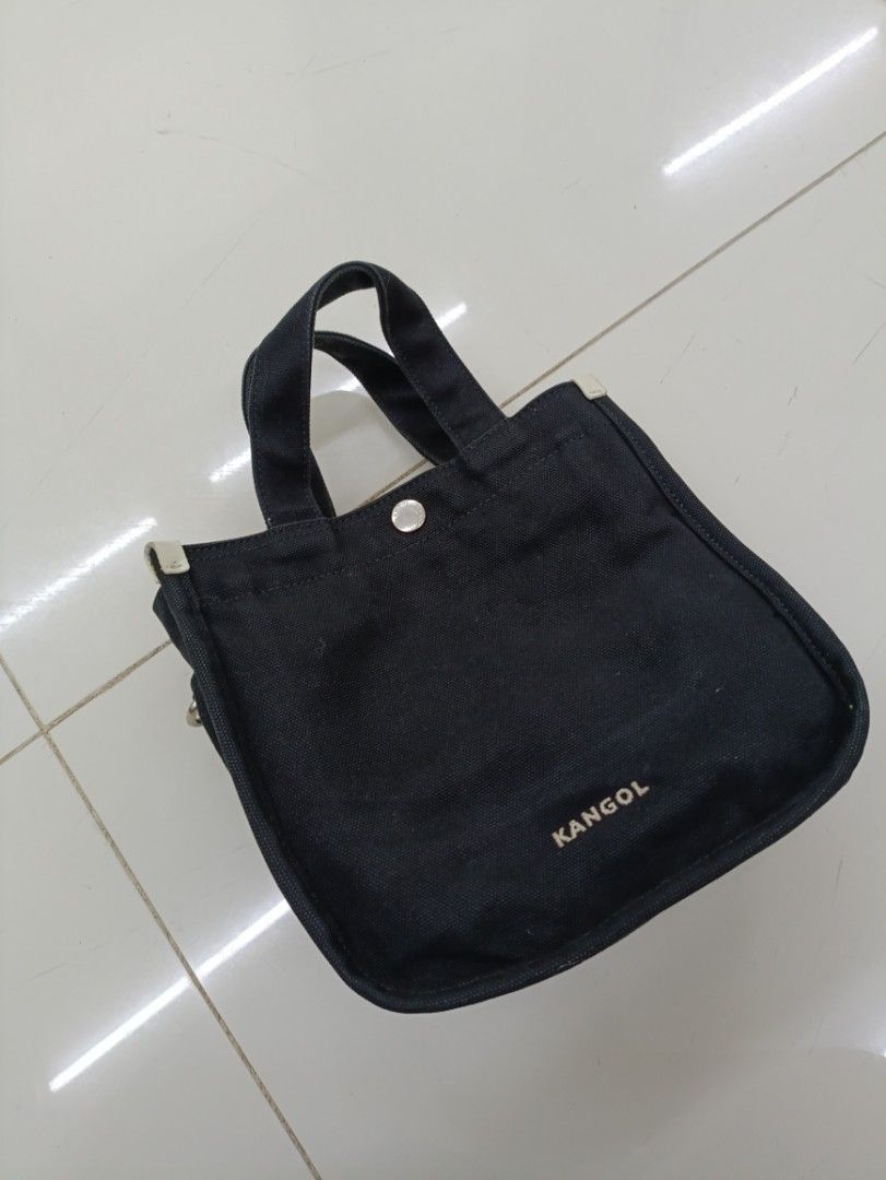 Kangol Black Canvas Tote Bag with Strap (Category: Sling Bags) located in Quezon City. Submitted by daniel_thrift05 (Listing ID 1441265702, Image 3). Description: - Brand: Kangol - Color: Black - Material: 100% Cotton Canvas - Features: Top handles, detachable shoulder strap, front zip pocket, main compartment - Design: Embroidered Kangol logo on front - Size: OS (One Size).
