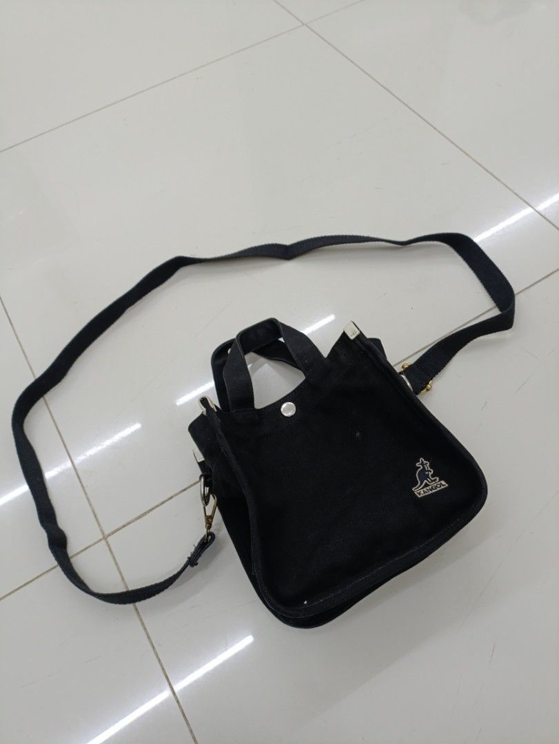 Kangol Black Canvas Tote Bag with Strap (Category: Sling Bags) located in Quezon City. Submitted by daniel_thrift05 (Listing ID 1441265702, Image 1). Description: - Brand: Kangol - Color: Black - Material: 100% Cotton Canvas - Features: Top handles, detachable shoulder strap, front zip pocket, main compartment - Design: Embroidered Kangol logo on front - Size: OS (One Size).