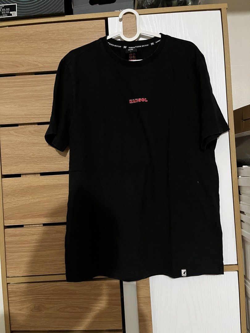 Kangol Black T-Shirt XL (Category: Tshirts & Polo Shirts ) located in Manila. Submitted by shopthevintage (Listing ID 1441346741, Image 1). Description: - Black Kangol T-shirt - Size: XL - Small red Kangol logo on the front - Red '38 Kangol' graphic on the back near the neck - Comfortable for everyday wear.