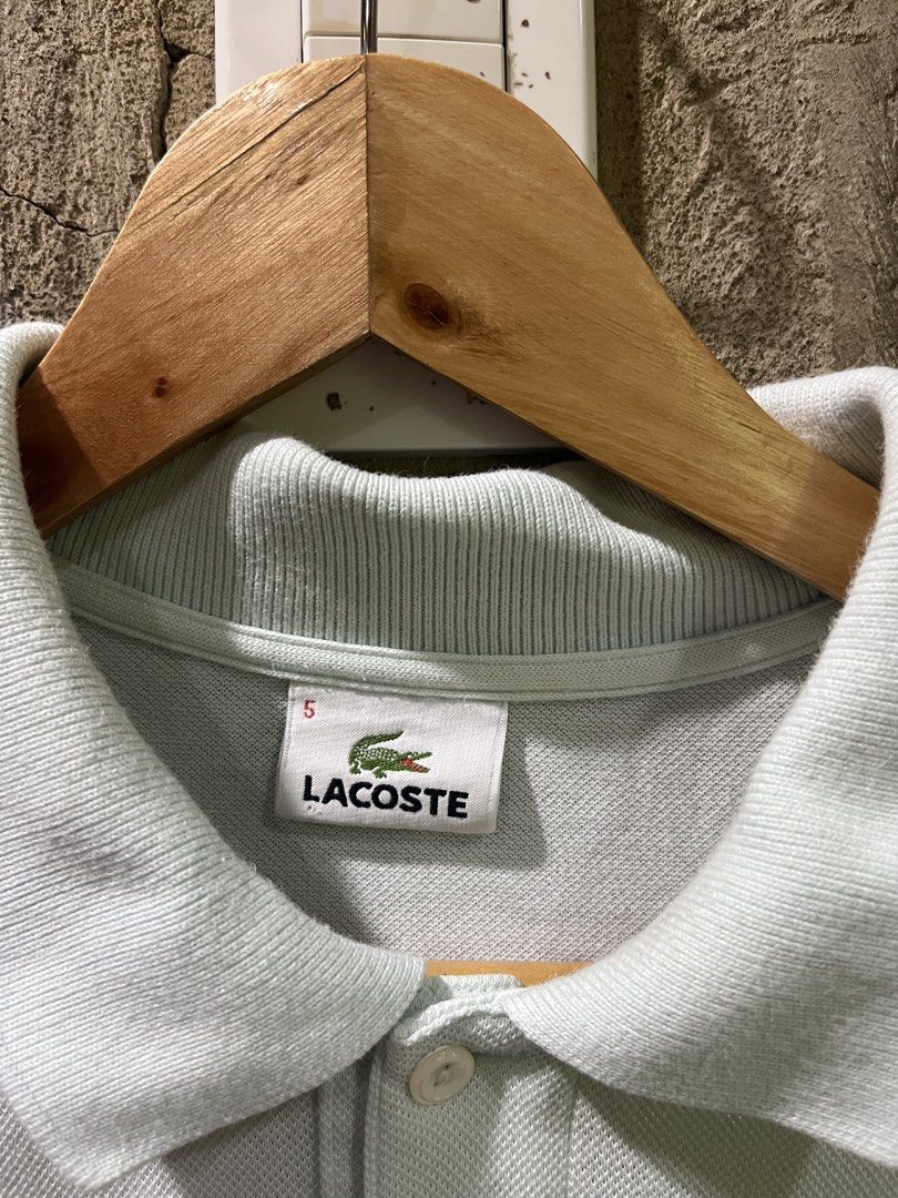 Lacoste Polo Shirt Light Blue Size 5 (Category: Tshirts & Polo Shirts ) located in Manila. Submitted by christian048 (Listing ID 1441223458, Image 3). Description: - Light blue Lacoste polo shirt - Classic design with iconic crocodile logo - Button-up collar - Tag size: 5 - Comfortable cotton material - Ideal for casual or smart-casual outfits - dimes : 21 x 29 - Authentic .