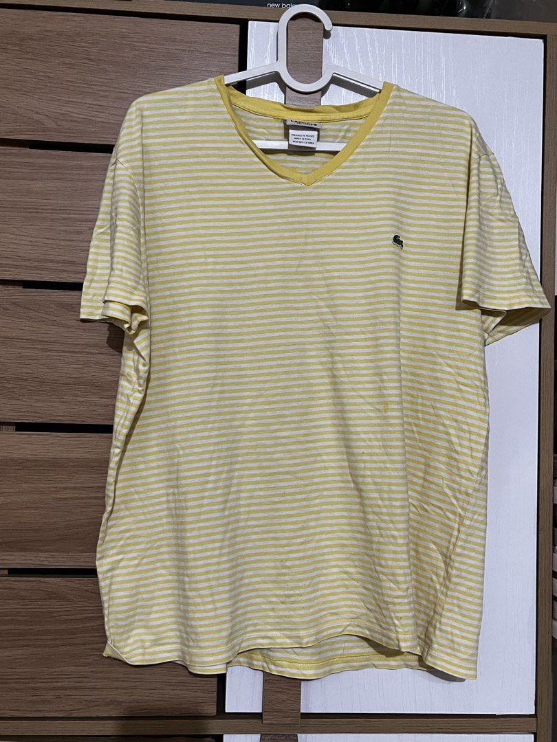 Lacoste Regular Fit Striped V-Neck Tshirt Yellow (Category: Tshirts & Polo Shirts ) located in Manila. Submitted by shopthevintage (Listing ID 1441344467, Image 1). Description: - Brand: Lacoste - Color: Yellow and white stripes - Neckline: V-neck - Fit: Regular fit - Logo: Small crocodile logo on chest - Origin: Made in Peru - Style: Great for casual wear.