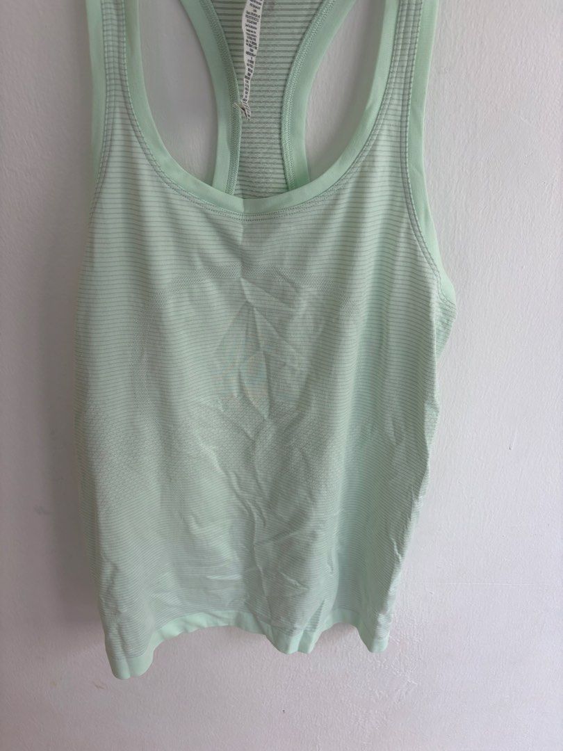 Lululemon Mint Green Striped Racerback Tank Top (Category: Sleeveless) located in Singapore. Submitted by 57363739322 (Listing ID 1441199129, Image 2). Description: - Lululemon tank top - Colour: Mint green - Style: Racerback with subtle horizontal stripes - Fabric: Lightweight and breathable - Versatile: Suitable for workouts or casual wear - Condition: Minimal signs of wear.