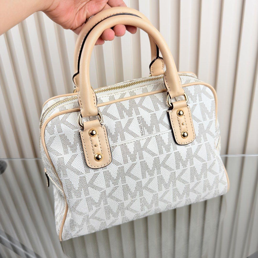 Michael Kors Monogrammed Dome Satchel Bag (Category: Luxury Bags & Wallets) located in Pasig City. Submitted by trendapparelph (Listing ID 1441198880, Image 3). Description: - Authentic Michael Kors satchel in white and beige. - Features the iconic MK monogram print all over. - Accented with elegant tan leather trim and handles. - Stylish gold hardware details. - Secure zipper closure for your essentials. - Includes original small card. - An idea