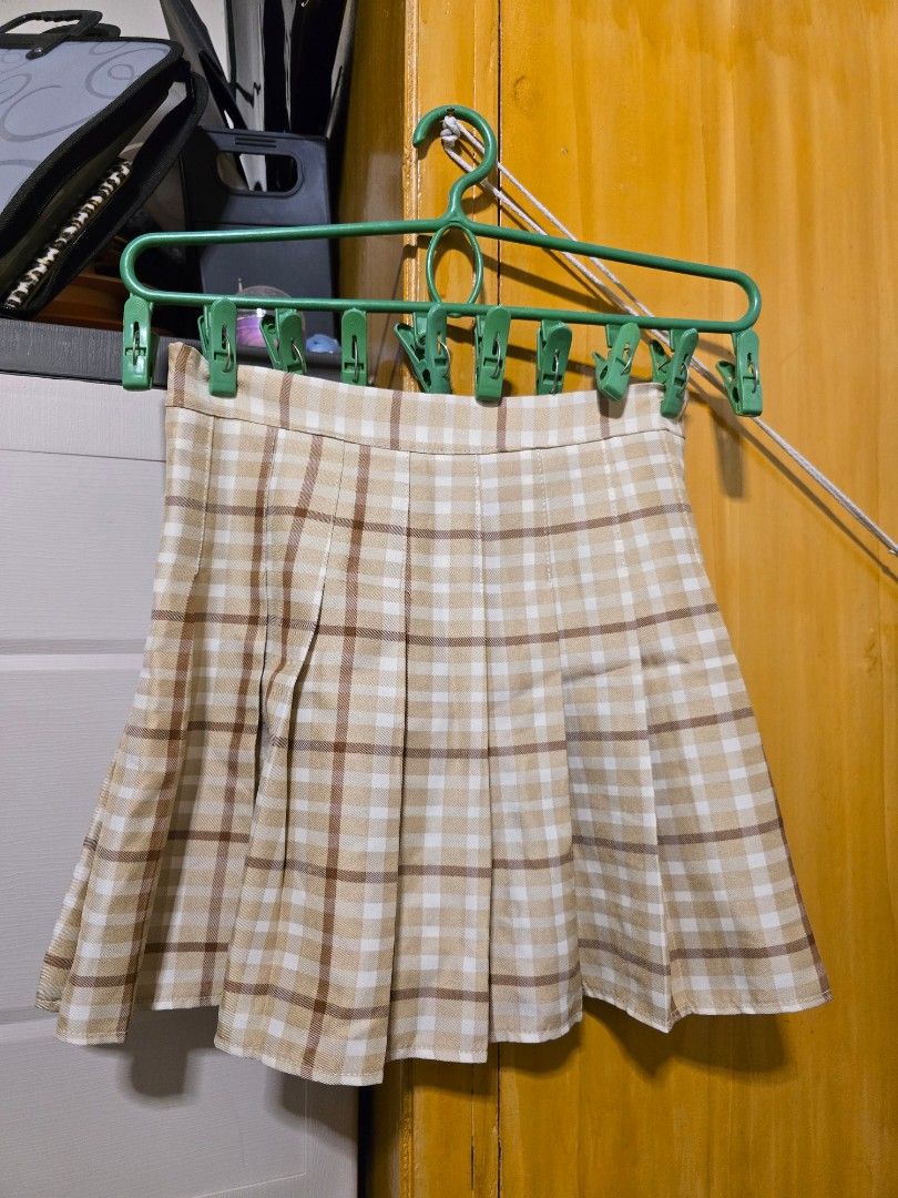 Milkshake Plaid Pleated Mini Skirt Size M (Category: Skirts) located in Manila. Submitted by yzahmae (Listing ID 1441291996, Image 3). Description: - Cute plaid mini skirt from Milkshake - Classic pleated design - Neutral beige with brown and white checks - Versatile: pairs well with crop tops or t-shirts - Ideal for casual outings or nights with friends - Size: Medium ( 28 inches waistline).