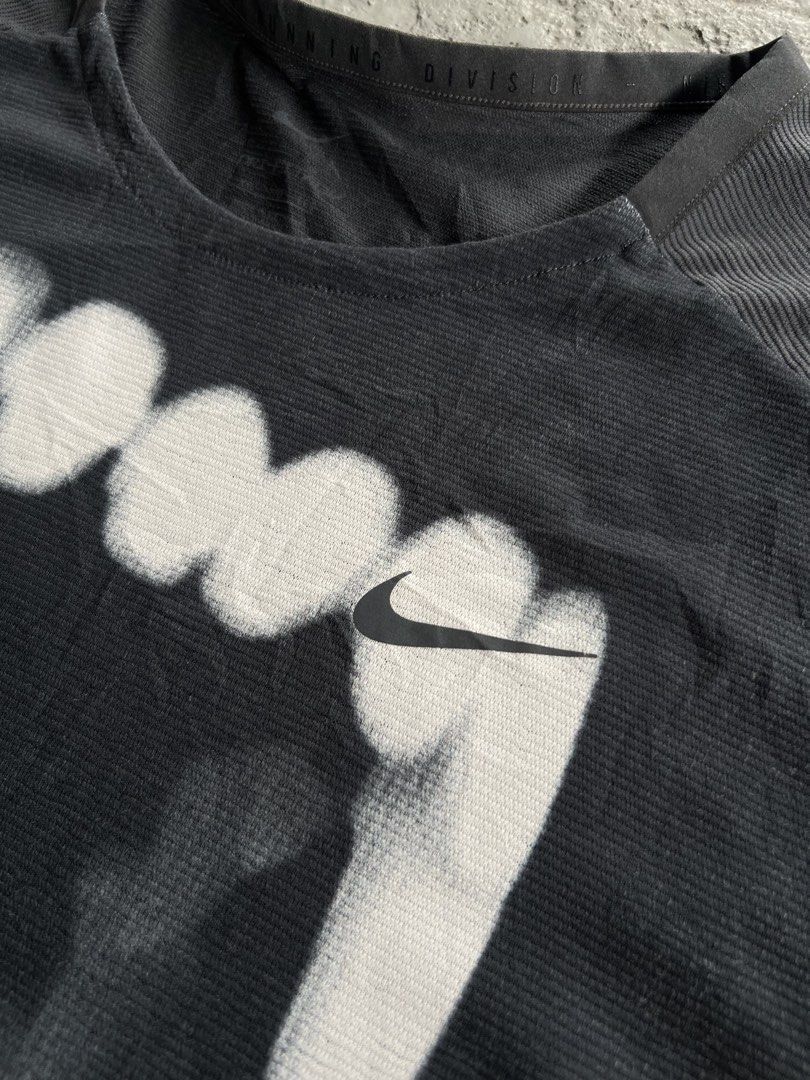 NikeADV Running Division Graphic T-Shirt (Category: Tshirts & Polo Shirts ) located in Mabalacat. Submitted by sweatout.ph2025 (Listing ID 1441219340, Image 2). Description: Dimes: 28x22 - Grey Nike t-shirt - Cool graphic print on front - Features Nike Running Division logo - Short sleeves, crew neck - Made with performance fabric - Ideal for workouts or casual wear - Please check photos for condition details.