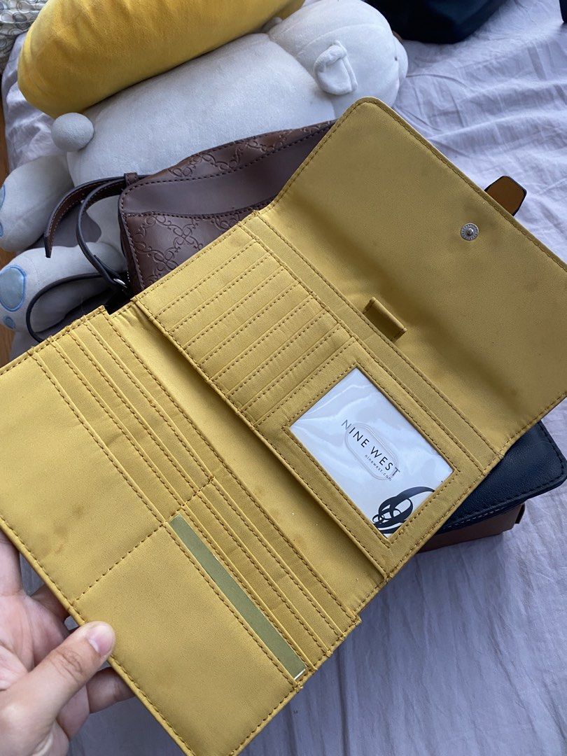 Nine West Yellow Leather Long Wallet (Category: Wallets & Card holders) located in Manila. Submitted by mpt99876 (Listing ID 1441238796, Image 2). Description: - Genuine yellow Nine West leather wallet - Secure snap closure - Ample card slots for organization - Clear ID window for easy access - Minor marks on interior lining, does not affect functionality.