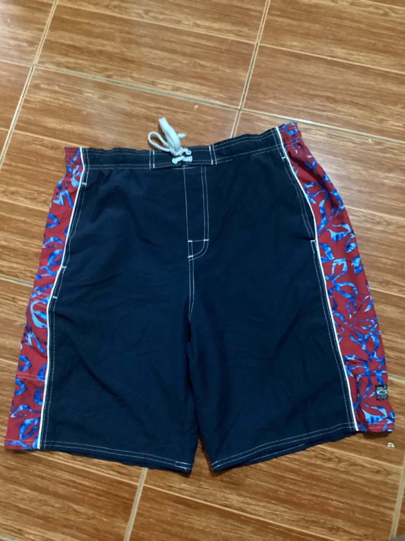 Ocean Pacific sports tag (Category: Swim Trunks & Board Shorts) located in Mangaldan. Submitted by manuelingalla_3rd (Listing ID 1441283810, Image 3). Description: - Navy blue swim trunks - Red and blue floral pattern on sides - Elastic waistband with drawstring - Oakley logo on back pocket - Suitable for swimming and lounging -Dimes: 34-40/21/12.