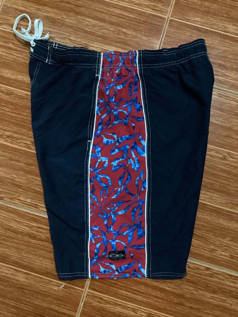 Ocean Pacific sports tag (Category: Swim Trunks & Board Shorts) located in Mangaldan. Submitted by manuelingalla_3rd (Listing ID 1441283810, Image 2). Description: - Navy blue swim trunks - Red and blue floral pattern on sides - Elastic waistband with drawstring - Oakley logo on back pocket - Suitable for swimming and lounging -Dimes: 34-40/21/12.