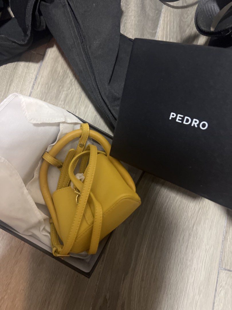 Pedro Yellow Mini Bucket Bag with Box (Category: Cross-body Bags) located in Singapore. Submitted by droppylees (Listing ID 1441314935, Image 1). Description: - Brand: Pedro - Color: Yellow - Style: Mini bucket bag - Features: Detachable strap, top handles - Includes: Original Pedro box - Perfect for: Adding a pop of color to your outfit - unused but kept in storage for quite some time; was a gift .