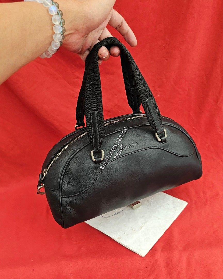 🛑Prada Black Leather Zip Bowler Bag (Category: Luxury Bags & Wallets) located in Baguio. Submitted by bagluxers_haven (Listing ID 1441302408, Image 2). Description: 🛑Authentic Prada Black Soft Calfskin Leather Zip Closure Bowler Bag w/ Dual Flat Canvas Top Handle & a Digital Padlock 》Small to medium w/ a spacious jacquard lined interior. 》Djom Djom 🛑Lightly Used, Very Good Condition but no more inclusions. No Flaw. 🛑DIMENSION : 11.5"L X 6"H X