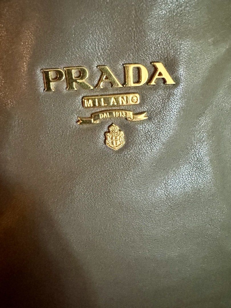 Prada Milano Leather Tote Bag Gold Hardware (Category: Luxury Bags & Wallets) located in Balagtas. Submitted by bulacan_goods (Listing ID 1441185993, Image 3). Description: - Authentic Prada Bag - Material: Soft Grey Leather - Hardware: Gold-tone - Features: Buckle details, Top handles - Interior: Spacious - Versatile: Ideal for daily use or special occasions - Style: Classic Prada piece.