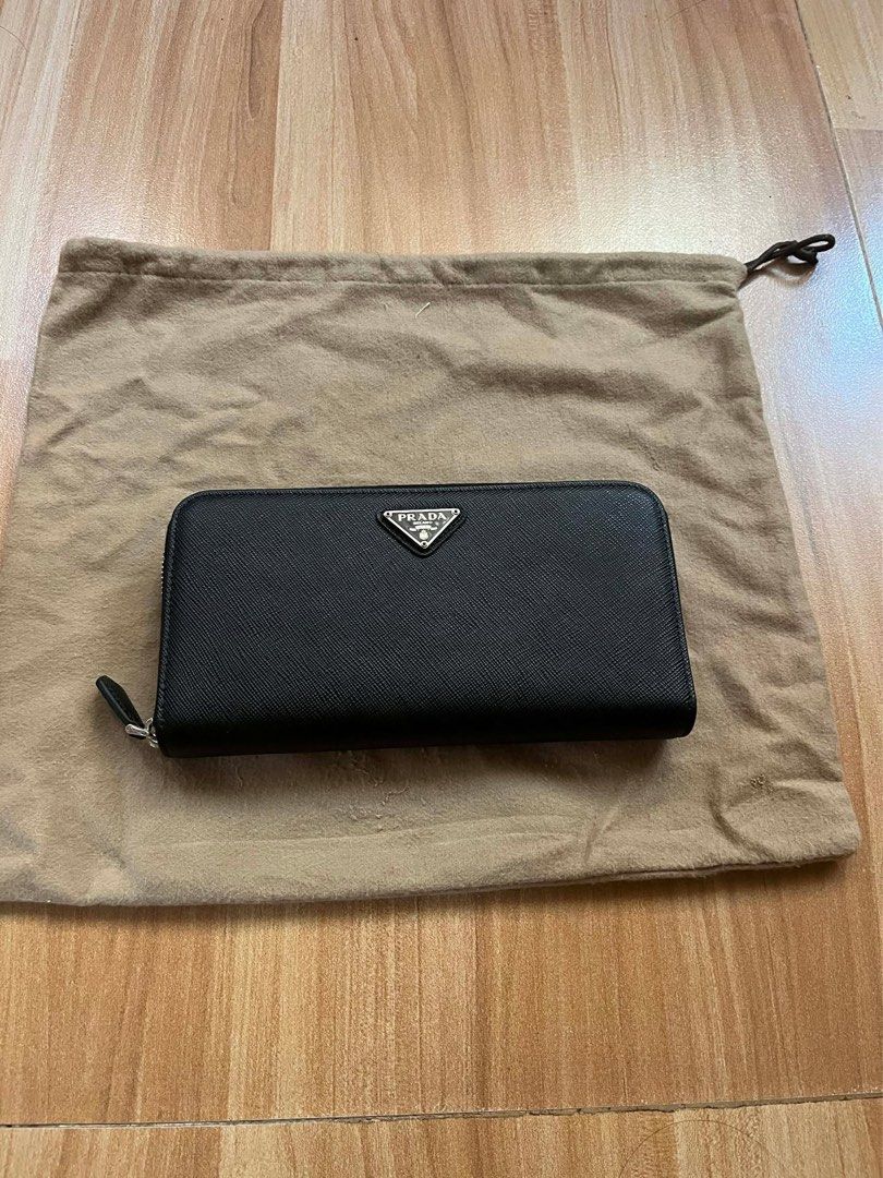 Prada Saffiano Leather Zip Around Wallet Black (Category: Luxury Bags & Wallets) located in Victorias. Submitted by lan1877 (Listing ID 1441184391, Image 1). Description: - Authentic Prada Wallet Rank SA - Black Saffiano Leather - Zip-around Closure - Multiple Card Slots & Compartments - Includes Dust Bag - Made in Italy - Ideal for organizing essentials.