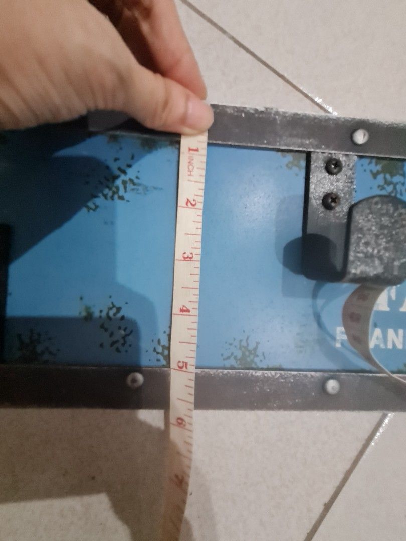 Retro wooden cloth hanger (Category: Wall Decor) located in Quezon City. Submitted by declutter1990 (Listing ID 1441163430, Image 3). Description: - Cool vintage-style sign - Features '126' and 'FACTORY FRANKFURT AIRPORT' - Metal frame with rivets - Blue distressed background - Two latches on the front - Ideal for a man cave or workshop - Approximate dimensions: 24 inches long x 6 inches tall.