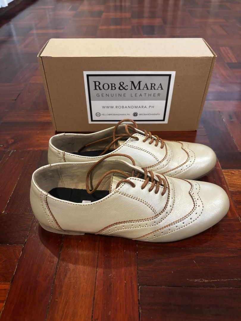 Rob & Mara Genuine Leather Wingtip Oxfords (Category: Loafers) located in Quezon City. Submitted by jcs_items (Listing ID 1441172369, Image 2). Description: - Rob & Mara genuine leather oxfords - Classic wingtip design with brogue detailing - Elegant light gold/champagne shimmer color - Durable rubber soles with R/M branding - Comes with original box.