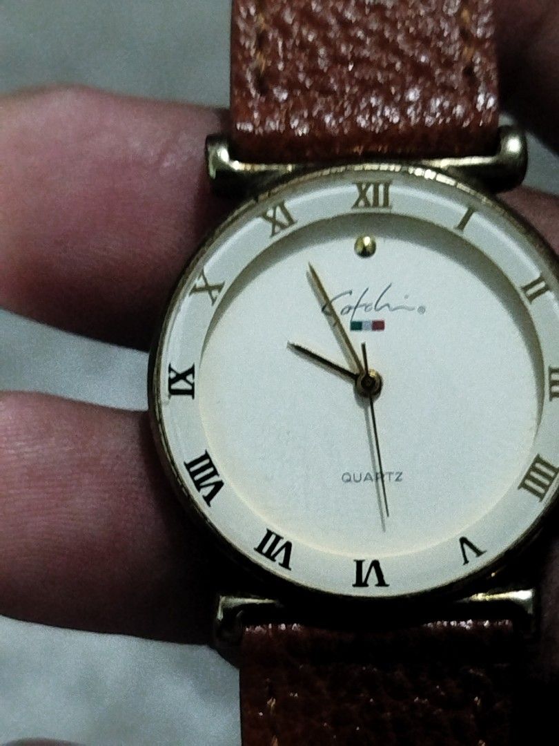 Satchi Quartz Watch italy with Leather Strap (Category: Men's Watches) located in Subic. Submitted by regiedaniel01 (Listing ID 1441318604, Image 3). Description: - Kotlario Quartz Watch - Cream dial with Roman numerals - Gold-tone case - Genuine brown textured leather strap - Simple and classic design - In good working condition.