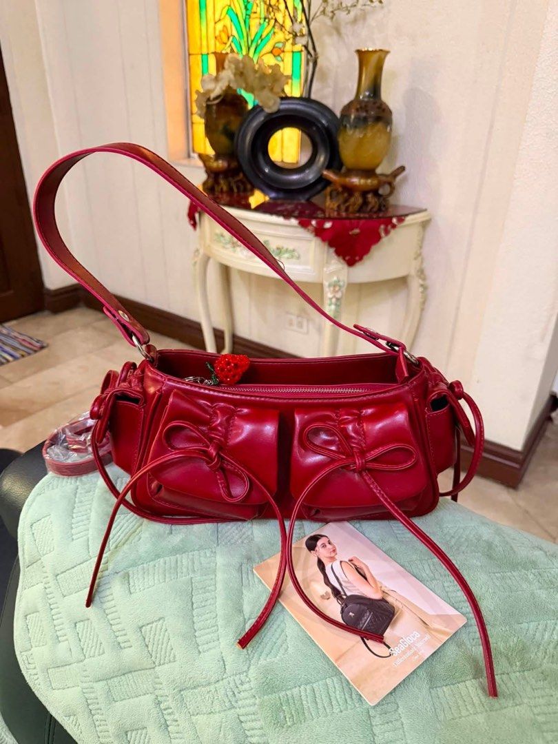 SeaGloca Bow Pleated Drawstring Underarm Shoulder Bag/Crossbody Bag For Woman (Category: Shoulder Bags) located in Meycauayan. Submitted by sweet.cherry.ph (Listing ID 1441290676, Image 2). Description: - Genuine red leather shoulder bag by See By Chloé - Adorable bow detail on front pockets - Secure zipper closure - Interior small zipped pocket for essentials - Includes original dust bag - Ideal for everyday wear Pwedeng sholuder bag pwede din s