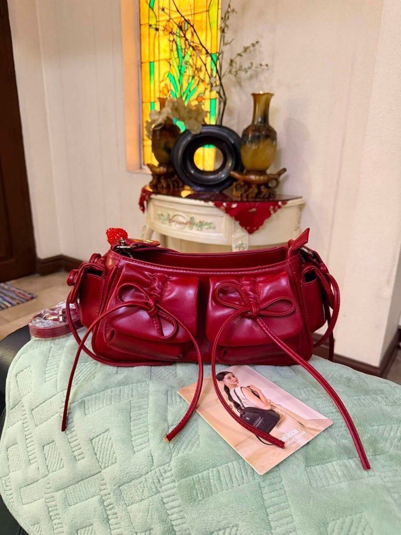 SeaGloca Bow Pleated Drawstring Underarm Shoulder Bag/Crossbody Bag For Woman (Category: Shoulder Bags) located in Meycauayan. Submitted by sweet.cherry.ph (Listing ID 1441290676, Image 1). Description: - Genuine red leather shoulder bag by See By Chloé - Adorable bow detail on front pockets - Secure zipper closure - Interior small zipped pocket for essentials - Includes original dust bag - Ideal for everyday wear Pwedeng sholuder bag pwede din s