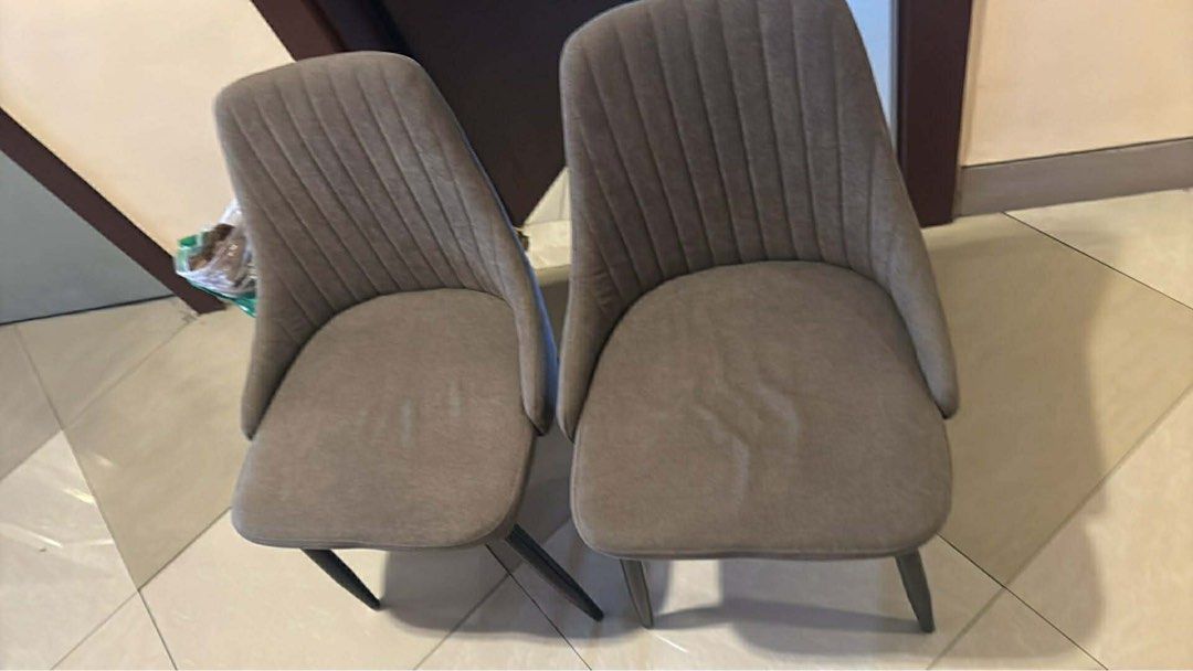 Set of 2 Grey Upholstered Dining Chairs (Category: Chairs) located in Manila. Submitted by popgoesthe40457 (Listing ID 1441170655, Image 1). Description: - Set of 2 grey upholstered dining chairs - Features a stylish ribbed back design - Sturdy dark legs - Versatile: perfect for dining rooms or as accent chairs.