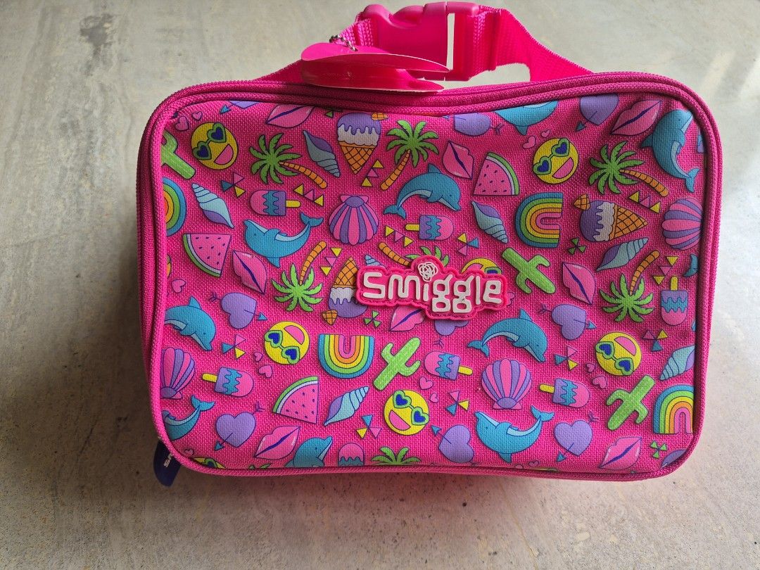 Brand new Smiggle Square Lunchboxes - Shark & Tropical Prints (Category: Babies & Kids Fashion) located in Singapore. Submitted by lucertola80299 (Listing ID 1441165148, Image 2). Description: - Set of 2 Smiggle square lunchboxes - Design 1: Navy blue with shark print - Design 2: Bright pink with tropical pattern - Both feature the Smiggle logo - Zippers are in good working condition - Ideal for school lunches or snacks.