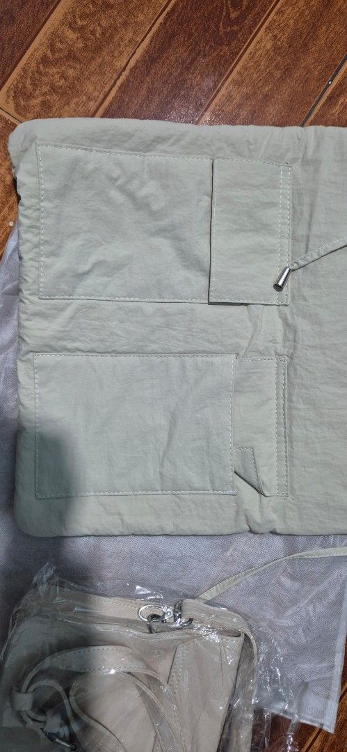 STRAIGHTFORWARD Beige Tote Bag with Matching Pouch (Category: Tote Bags) located in Las Pinas. Submitted by dressessfor_you (Listing ID 1441302687, Image 3). Description: - Stylish beige tote bag with a matching small pouch sling. - Tote features a secure drawstring closure and convenient exterior pockets. - Pouch has a flap closure with snap buttons for easy access. - Made from a lightweight, crinkled material for a unique look and feel. - Ideal