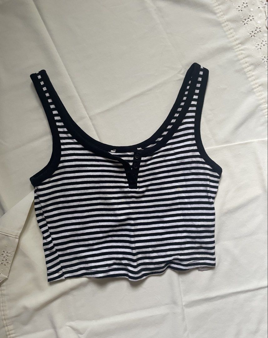 Striped Cropped Tank Top with Buttons (Category: Sleeveless) located in Quezon City. Submitted by declutter._.closet (Listing ID 1441226277, Image 1). Description: - Black and white striped cropped tank top - Scoop neckline with front button-up detail - Contrasting black trim on straps and neckline - Soft and stretchy material - Ideal for casual wear or layering.