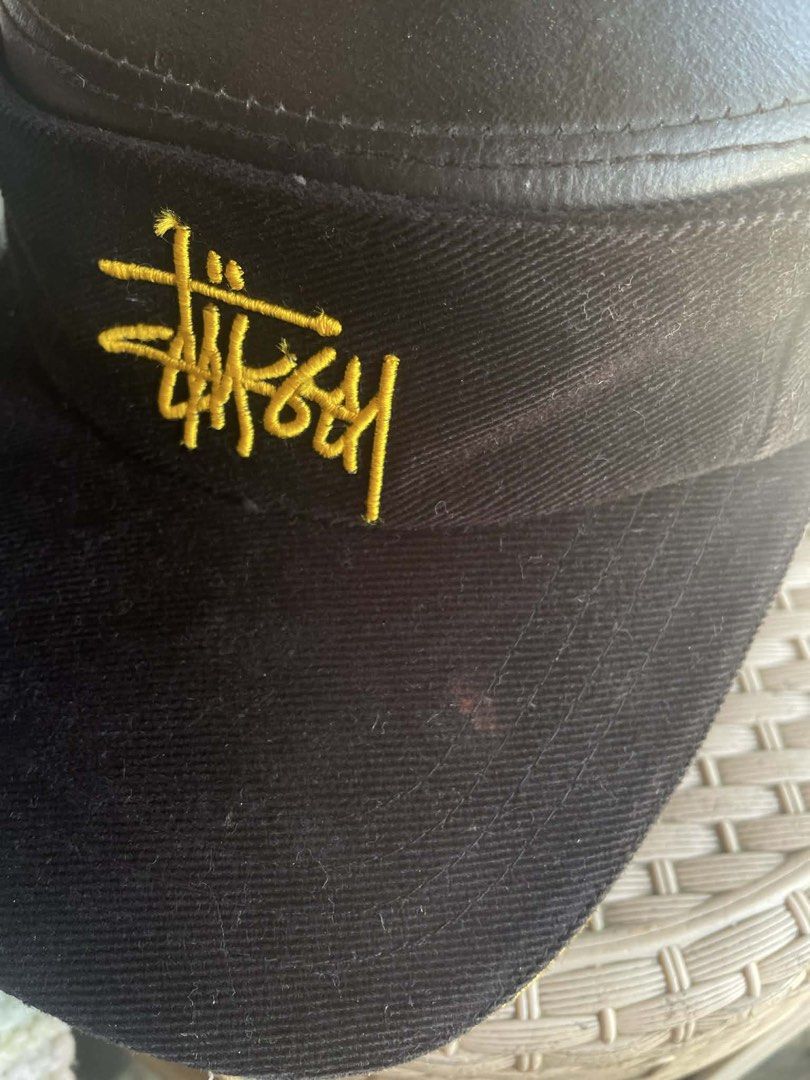 Stussy Black Visor Hat with Yellow Trim (Category: Caps & Hats) located in Baler. Submitted by shneyy (Listing ID 1441242623, Image 2). Description: - Black Stussy visor - Yellow trim around the brim - Embroidered yellow Stussy logo on the front - Adjustable strap at the back with Stussy branding - Ideal for sun protection and stylish wear.