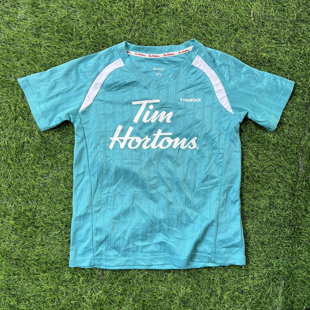 Tim Hortons FreeKick T-shirt (Category: Babies & Kids Fashion) located in Cuyapo. Submitted by Ashtyn.Pre.Loved (Listing ID 1441372695, Image 1). Description: - Teal Tim Hortons t-shirt - Features white Tim Hortons logo - Short sleeves with white shoulder accents - Brand: FreeKick - Ideal for casual wear.
