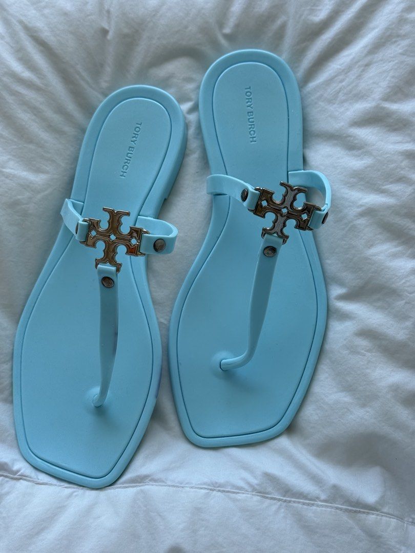 Tory Burch Jelly Sandals Light Blue (Category: Flats & Sandals) located in Mandaue City. Submitted by melbafelis47966 (Listing ID 1441202456, Image 1). Description: - Light blue Tory Burch jelly sandals - Classic thong style - Features iconic double T logo hardware - Comfortable and easy to slip on - Ideal for beach days or casual outings - Material: Rubber/Jelly - Approximate length: 10 inches - Free shipment.