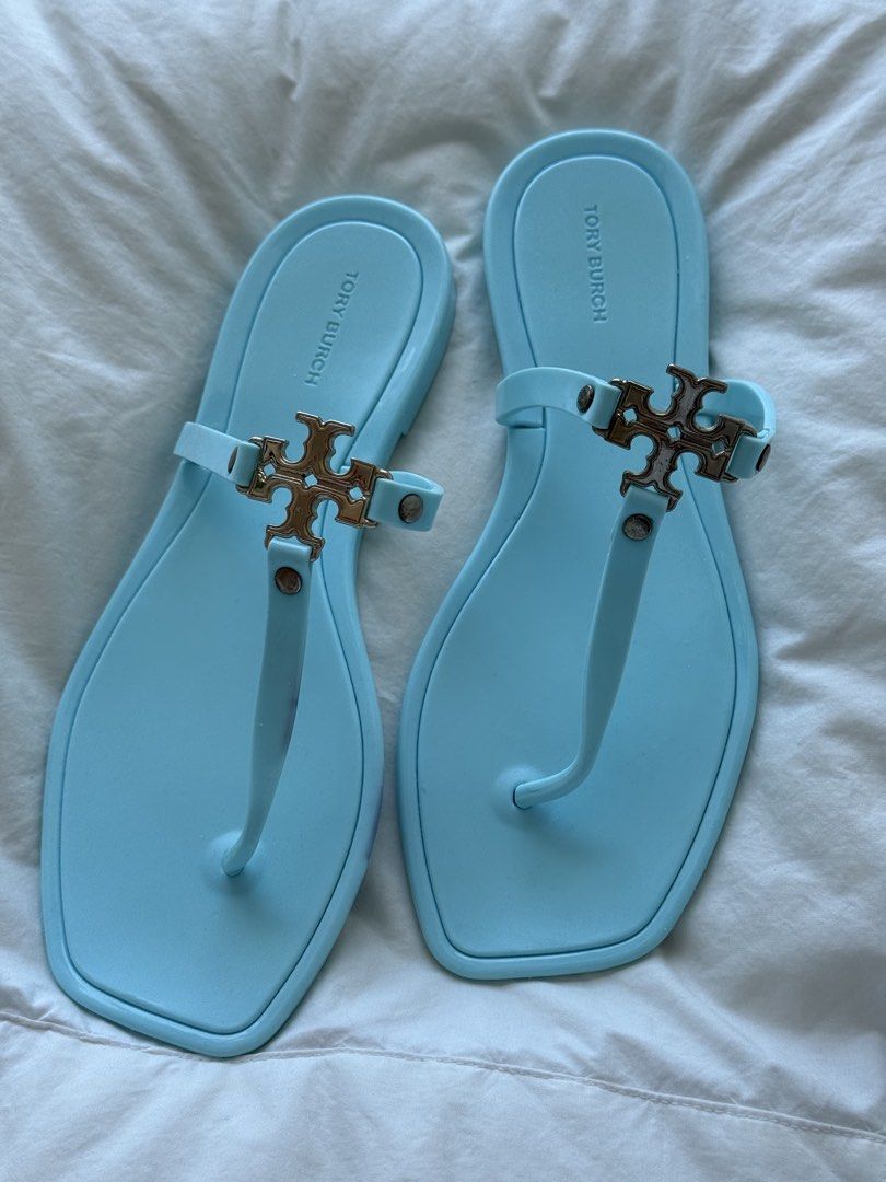 Tory Burch Jelly Sandals Light Blue (Category: Flats & Sandals) located in Mandaue City. Submitted by melbafelis47966 (Listing ID 1441202456, Image 2). Description: - Light blue Tory Burch jelly sandals - Classic thong style - Features iconic double T logo hardware - Comfortable and easy to slip on - Ideal for beach days or casual outings - Material: Rubber/Jelly - Approximate length: 10 inches - Free shipment.