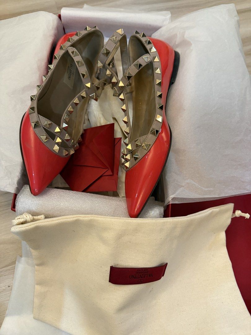 Valentino Rockstud pink Patent Leather Flats (Category: Flats & Sandals) located in Mandaluyong City. Submitted by kar510 (Listing ID 1441210795, Image 3). Description: - Valentino Rockstud flats - Red patent leather - Signature pyramid stud detailing - T-strap design - Includes original box, dust bag, and authenticity cards - Classic designer piece.