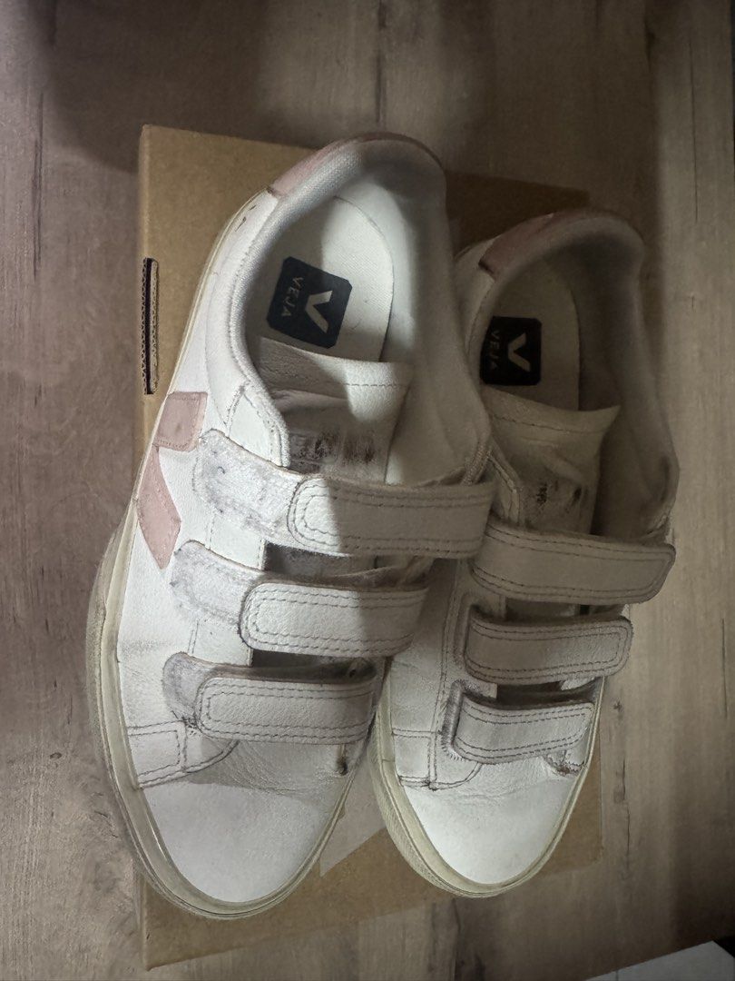 Veja White Pink Velcro Sneakers (Category: Sneakers) located in Taguig. Submitted by suzzsy (Listing ID 1441274291, Image 2). Description: - White Veja sneakers with pink accents. - Features easy-to-use velcro straps. - Perfect for everyday wear. - Shows some signs of wear on soles and leather (please check photos for details)..