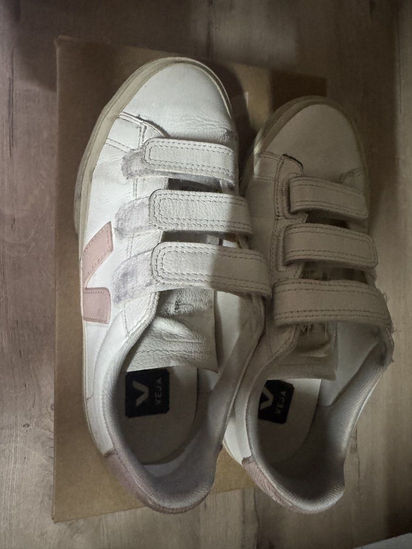 Veja White Pink Velcro Sneakers (Category: Sneakers) located in Taguig. Submitted by suzzsy (Listing ID 1441274291, Image 1). Description: - White Veja sneakers with pink accents. - Features easy-to-use velcro straps. - Perfect for everyday wear. - Shows some signs of wear on soles and leather (please check photos for details)..