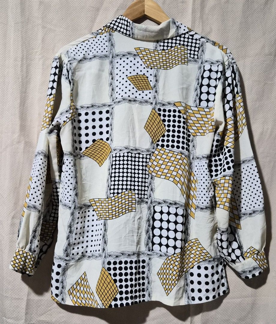 Vintage Geometric Print Button-Up Shirt (Category: Tshirts & Polo Shirts ) located in Mandaue City. Submitted by chuchi152615 (Listing ID 1441323931, Image 2). Description: - Unique retro button-up shirt - Eye-catching geometric and polka dot pattern - Cream base with black, white, and yellow accents - Long sleeves with button cuffs - Classic collar - Perfect for a statement outfit - Approximate measurements: 19 inches pit to pit.