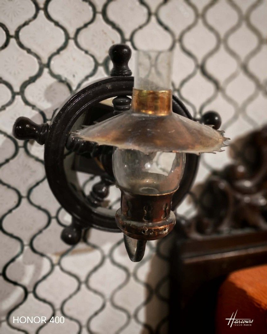 Vintage Nautical Ship Wheel Wall Sconce Lamp (Category: Lighting) located in Manila. Submitted by peeweemend69204 (Listing ID 1441232059, Image 1). Description: - Unique ship wheel design wall sconce - Features a clear glass hurricane shade - Rustic metal finish for a vintage/nautical look - Adds charm to hallways, living rooms, or themed spaces - Easy wall mounting - A great conversation starter.