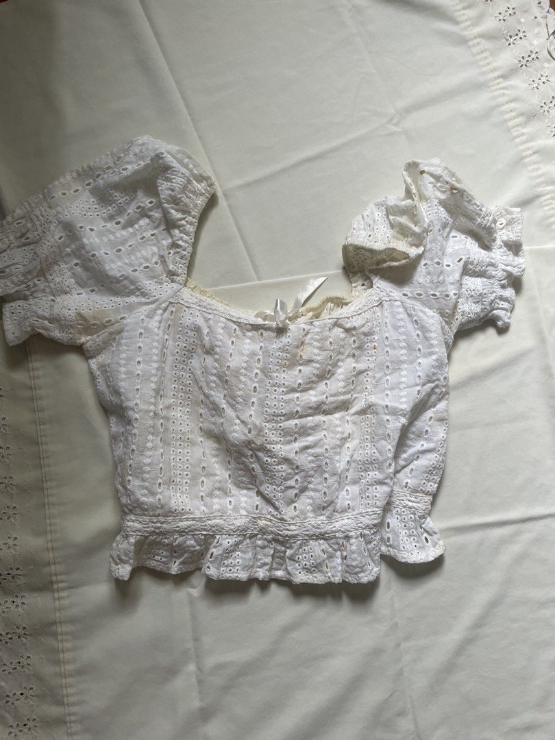 White Eyelet Puff Sleeve Square Neck Crop Top (Category: Blouses) located in Quezon City. Submitted by declutter._.closet (Listing ID 1441223541, Image 1). Description: - White eyelet crop top - Puff short sleeves with elastic cuffs - Square neckline with tie detail - Ruffled hem - Best fits size Small to Medium - Ideal for summer OOTDs.