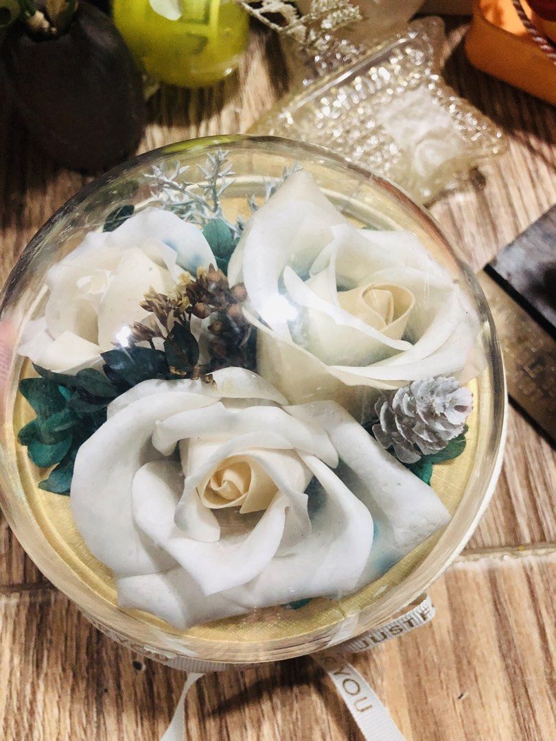 White Rose Preserved Flower Dome with Ribbon (Category: Flowers & Bouquets) located in Manila. Submitted by noemiaspa1702 (Listing ID 1441260739, Image 2). Description: - Beautiful preserved white roses - Encased in a clear dome - Comes in a round gift box - Features a 'Just For You' ribbon - Ideal for gifts or home decor - Realistic appearance - Long-lasting preservation - Adds a lovely touch to any space.