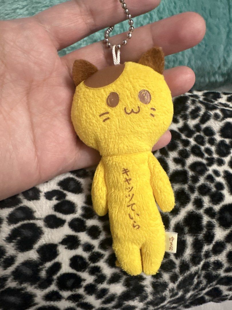 Yellow Cat Plush Keychain with Japanese Text (Category: Plushies & Soft Toys) located in Cainta. Submitted by shopbyyna (Listing ID 1441184205, Image 3). Description: - Adorable yellow cat plush toy - Features a convenient keychain - Decorated with Japanese writing on both sides - Compact and small size, ideal for attaching to bags or backpacks - Made with soft, huggable material - Authentic &M BANANA brand product.