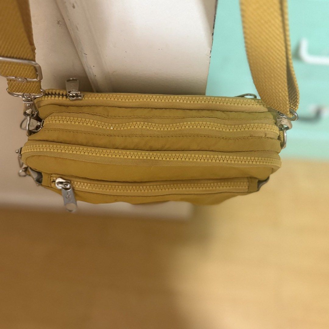 Yellow Kipling Crossbody Bag (Category: Cross-body Bags) located in Quezon City. Submitted by dtzee (Listing ID 1441314608, Image 2). Description: - Authentic Yellow Kipling Crossbody Bag - Multiple zippered compartments for organized storage - Adjustable strap for comfortable wear - Perfect for everyday use - Durable material built to last - Ample space for all your essentials.