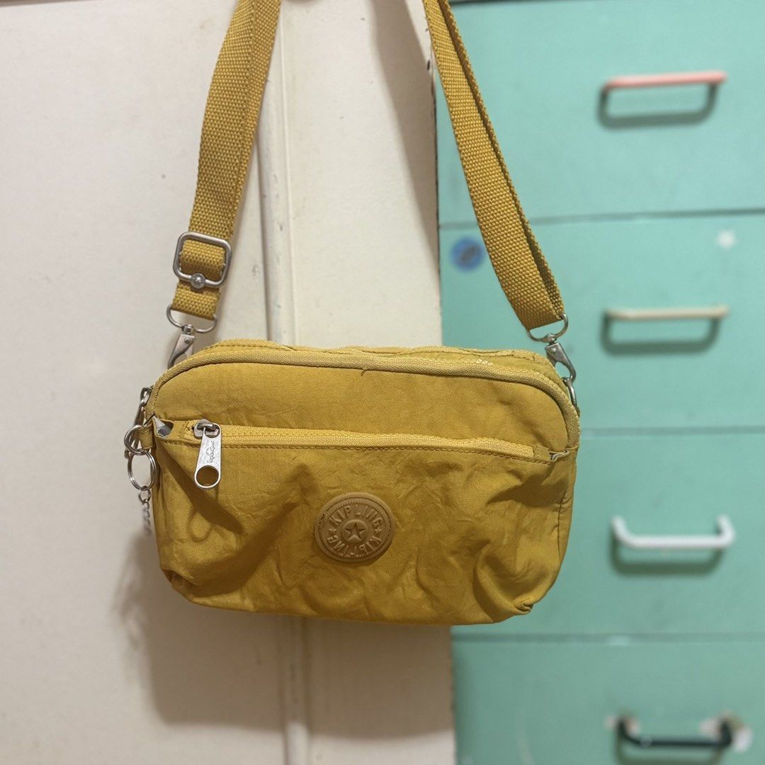 Yellow Kipling Crossbody Bag (Category: Cross-body Bags) located in Quezon City. Submitted by dtzee (Listing ID 1441314608, Image 1). Description: - Authentic Yellow Kipling Crossbody Bag - Multiple zippered compartments for organized storage - Adjustable strap for comfortable wear - Perfect for everyday use - Durable material built to last - Ample space for all your essentials.