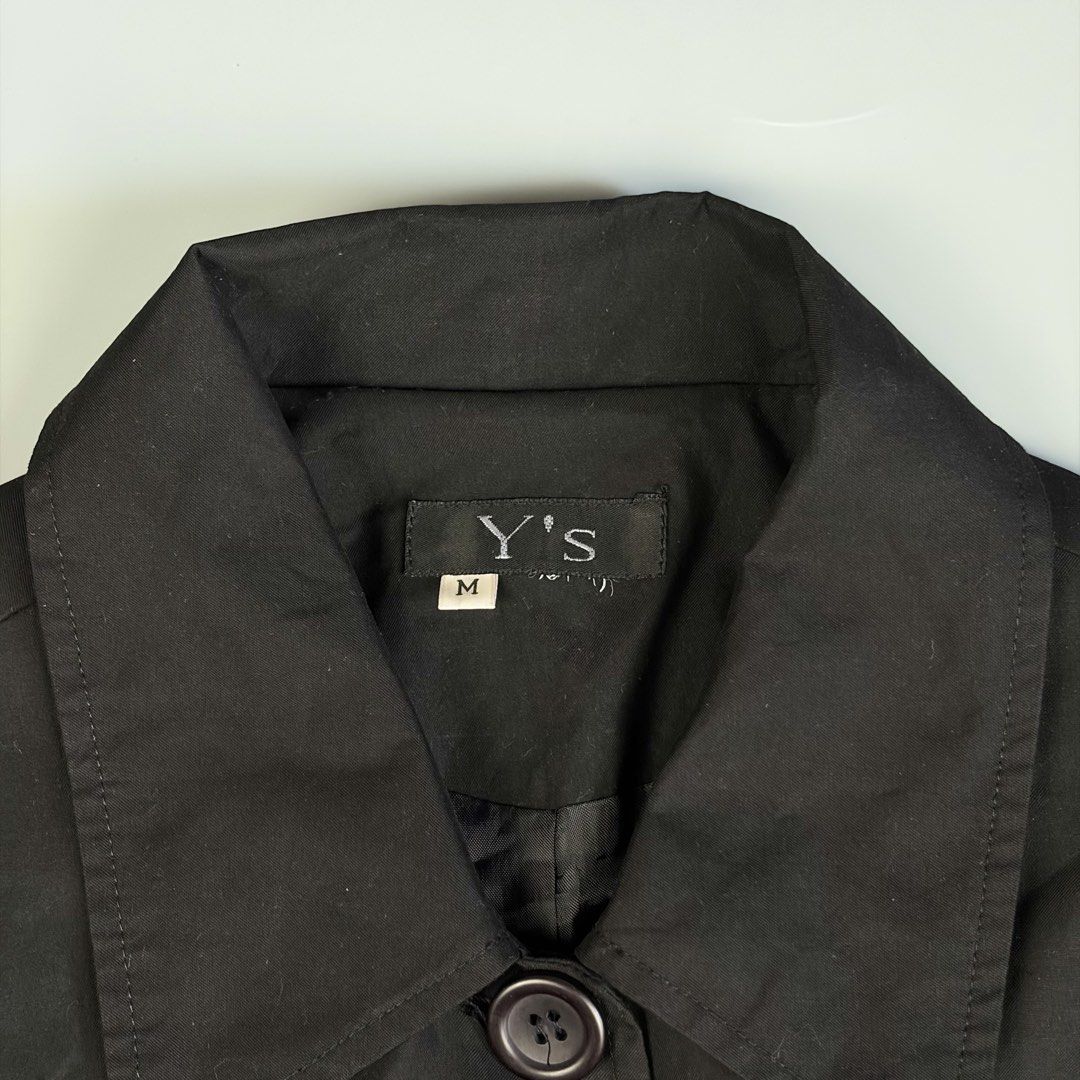 Y’s by Yohji Yamamoto Belted Short Trench Coat (Category: Luxury Apparel) located in Manila. Submitted by yourtherapist_ (Listing ID 1441190647, Image 2). Description: Y’s by Yohji Yamamoto Belted Short Trench Coat Unisex outerwear Size Medium Self authentication required as it does not have a care tag, although it has sign that it used to have some. No flaws Width - 18” Length - 29” Sleeve - 23” 1,500.