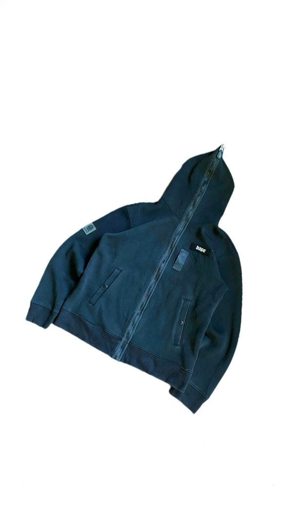 A Bathing Ape BAPE Full Zip Hoodie Size S (Category: Coats, Jackets and Outerwear) located in Montevista. Submitted by aguderaiva84994 (Listing ID 1443011777, Image 1). Description: - Brand: A Bathing Ape (BAPE) - Color: Black - Style: Full Zip Hoodie - Features: Iconic BAPE logo patch on sleeve and chest, BAPE logo zipper pull - Size: Tagged S - Ideal for: Casual wear.